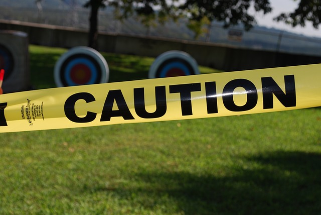 Yellow caution tape represents the need to be careful when selecting a home sharing agency.