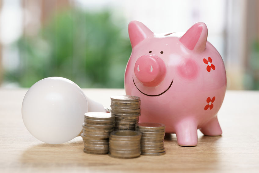 A piggy bank and light bulb symbolize how you could save money on your electric bill.